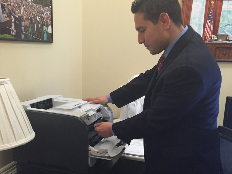 Jonathan servicing a printer in an office at the White House